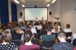 Zgromadzeni na sali uczniowie słuchają wystąpienia Dyrektora Izby Administracji Skarbowej w Rzeszowie